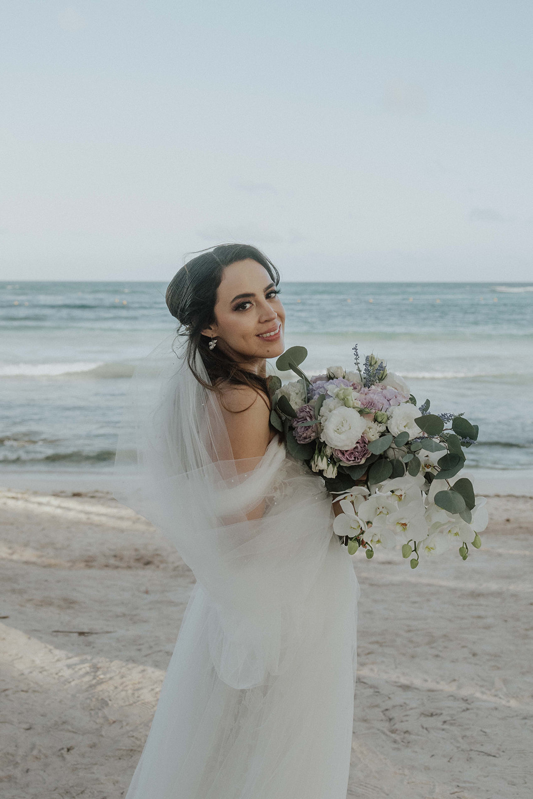 Couple at sunset on Grand Palladium Riviera Maya beach wedding